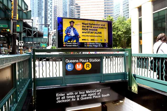 An MTA subway entrance showing a sign against subway surfing